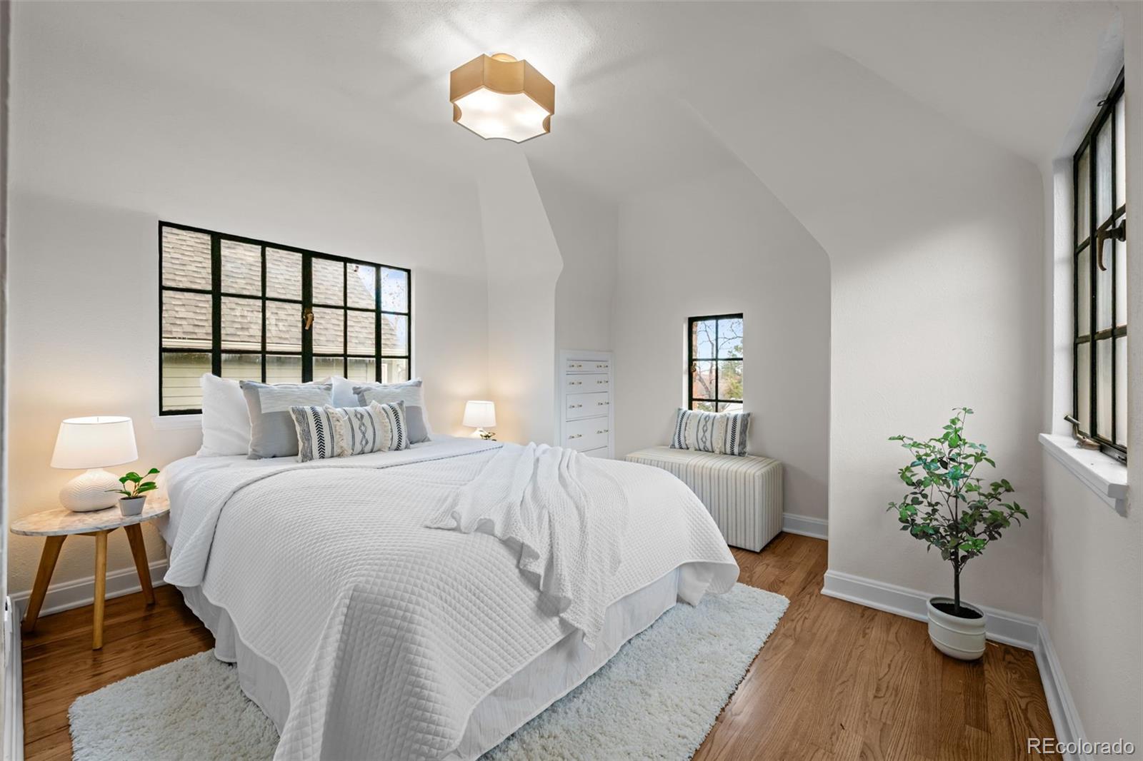 772 16th Street Boulder, CO 80302 - Photo 22 of 26 a bed room with a bed and a potted plant