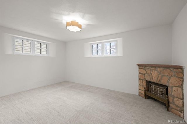 a view of an empty room with a fireplace