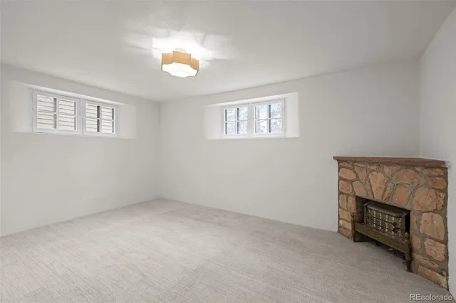 a view of an empty room with a fireplace