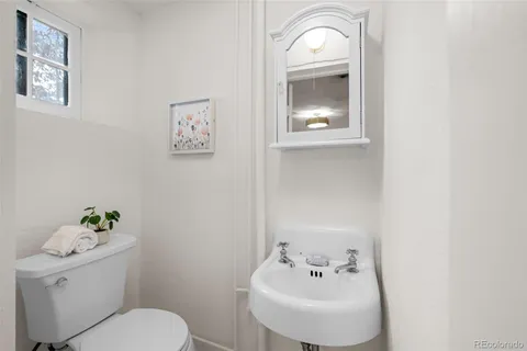 a bathroom with a toilet sink and mirror