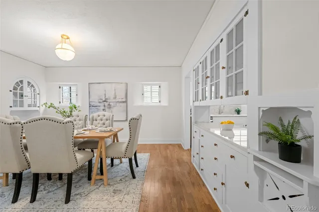 a view of a dining room with furniture and wooden floor