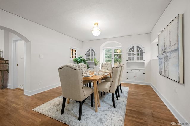 a view of a dining room with furniture and wooden floor
