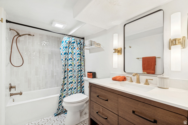 4883 South Center Street Murray, UT 84107 - Photo 21 of 32 Full Basement Bathroom. Bathroom featuring a wood-finish vanity with a white countertop and undermount sink