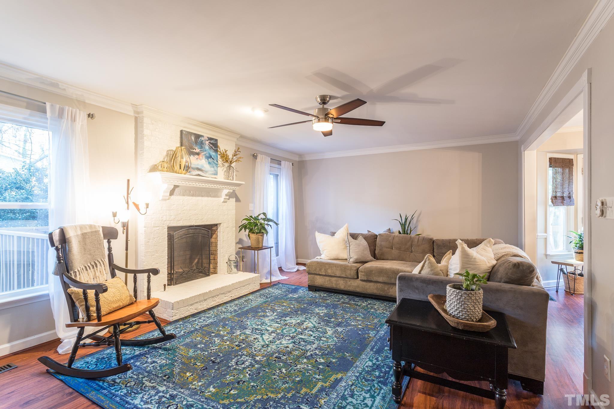 6924 Glendower Road Raleigh, NC 27613 - Photo 11 of 27 a living room with furniture a fireplace and a window