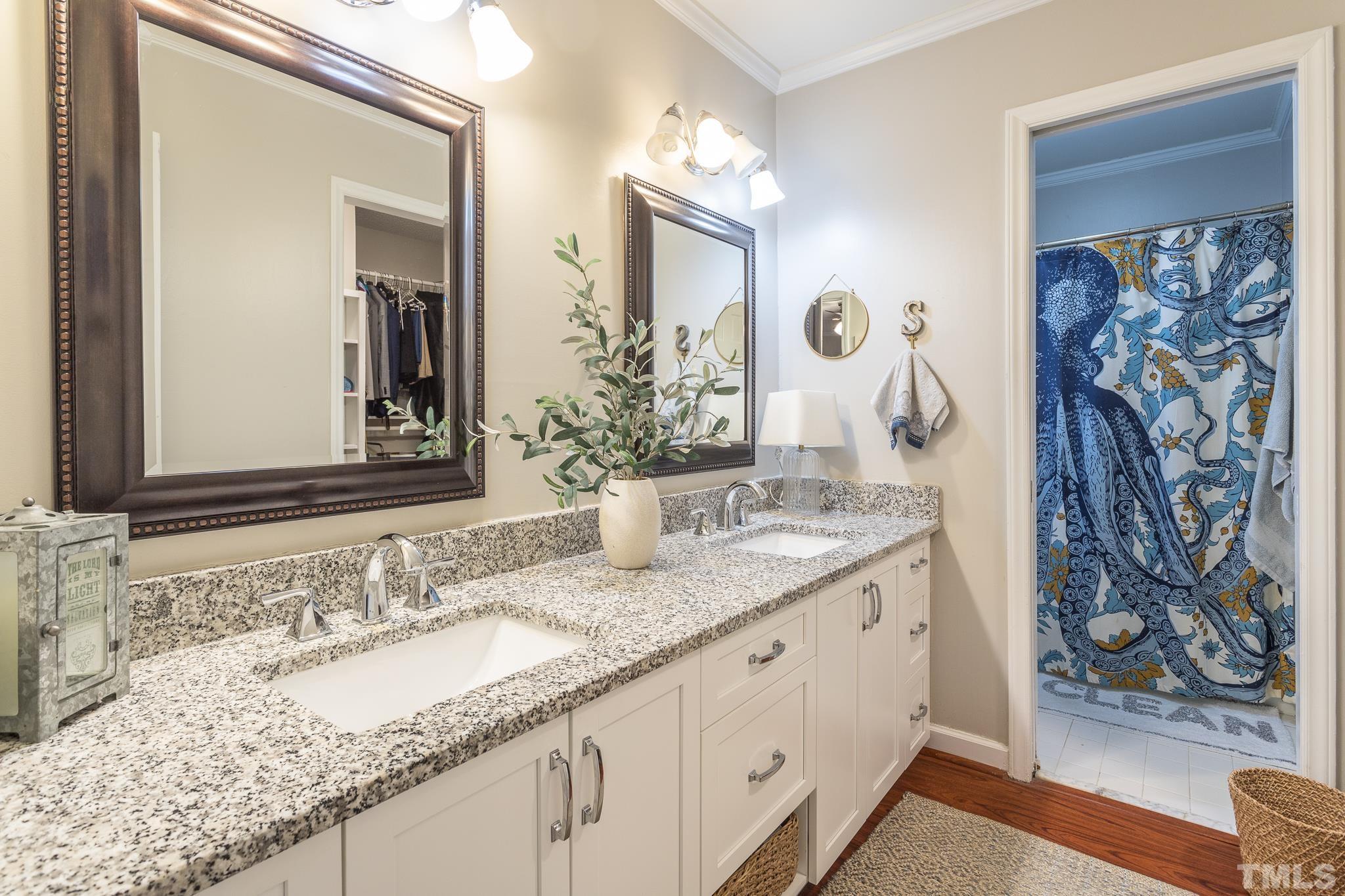 6924 Glendower Road Raleigh, NC 27613 - Photo 14 of 27 a bathroom with a granite countertop sink and a mirror