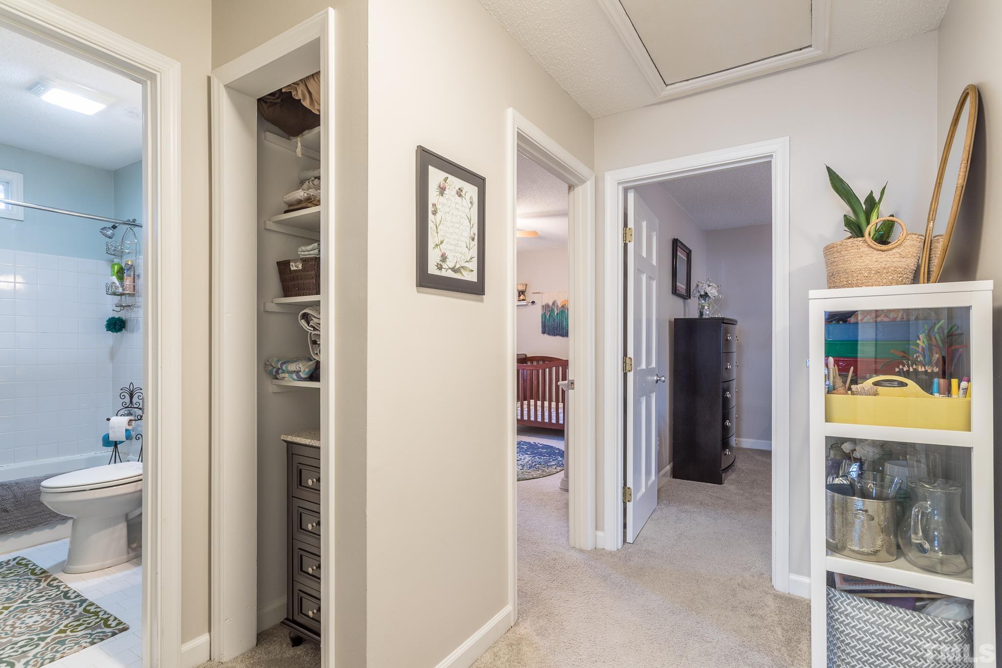 6924 Glendower Road Raleigh, NC 27613 - Photo 16 of 27 a bathroom with a toilet and a shower