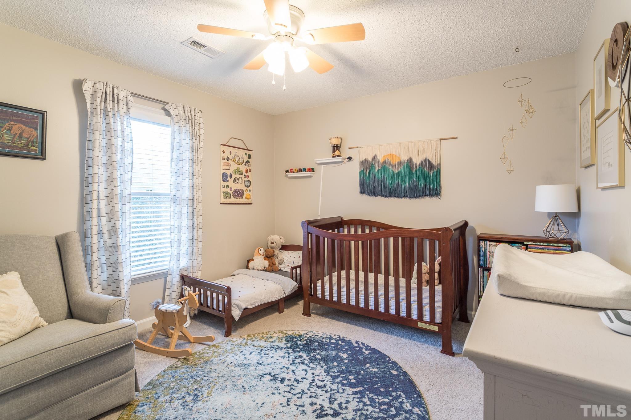 6924 Glendower Road Raleigh, NC 27613 - Photo 17 of 27 a bedroom with furniture and a rug
