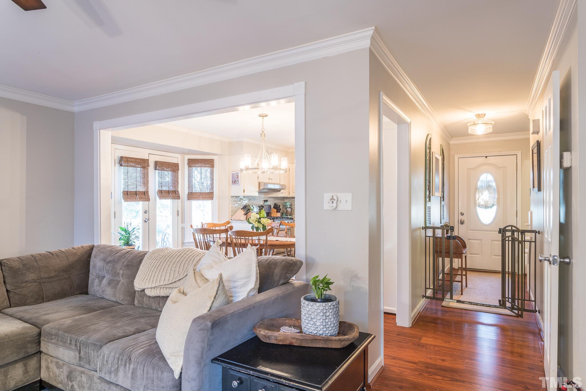 6924 Glendower Road Raleigh, NC 27613 - Photo 4 of 27 a living room with furniture and wooden floor