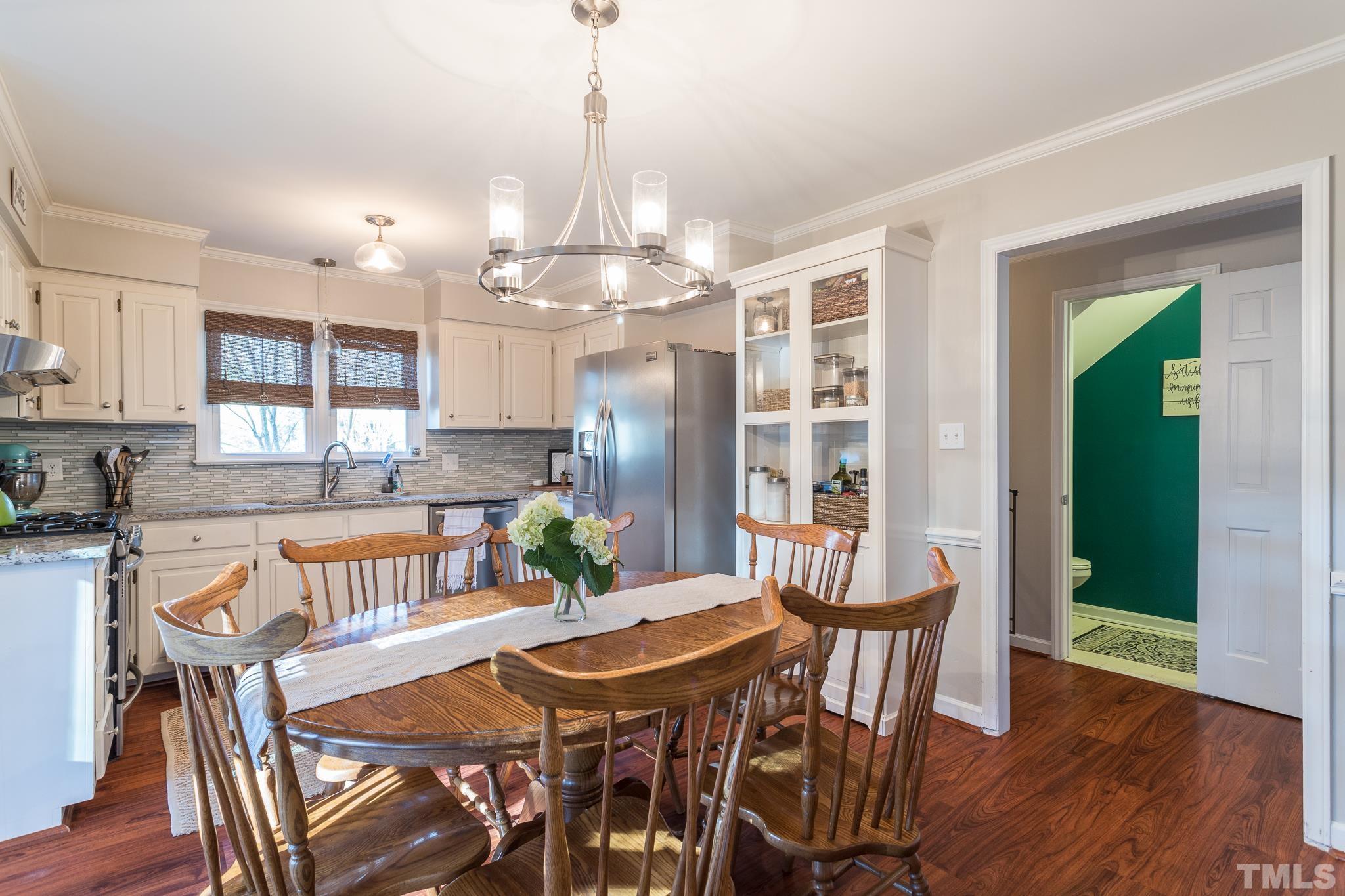 6924 Glendower Road Raleigh, NC 27613 - Photo 7 of 27 a view of a dining room with furniture window and wooden floor