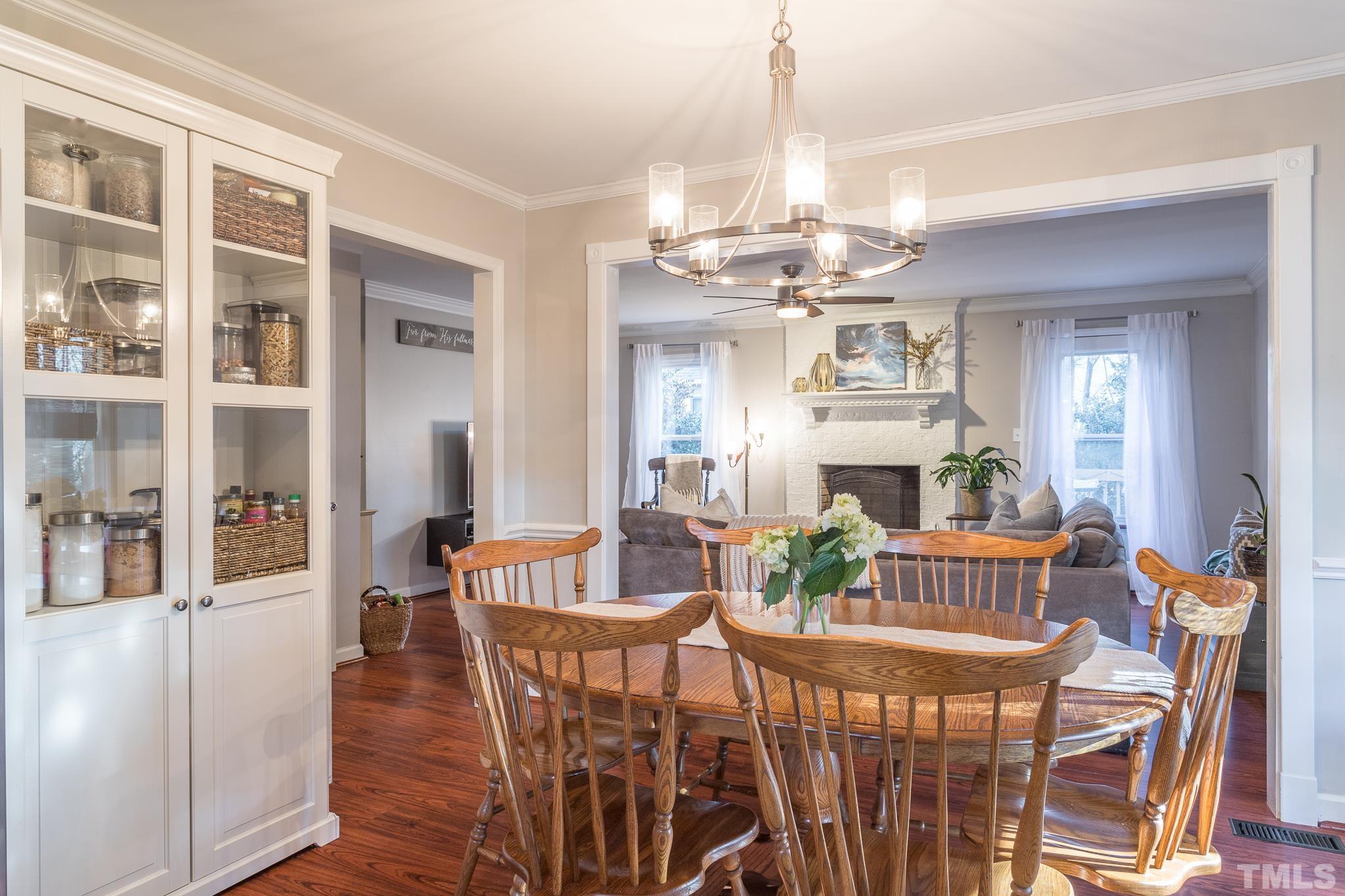 6924 Glendower Road Raleigh, NC 27613 - Photo 8 of 27 a view of a dining room with furniture wooden floor and chandelier