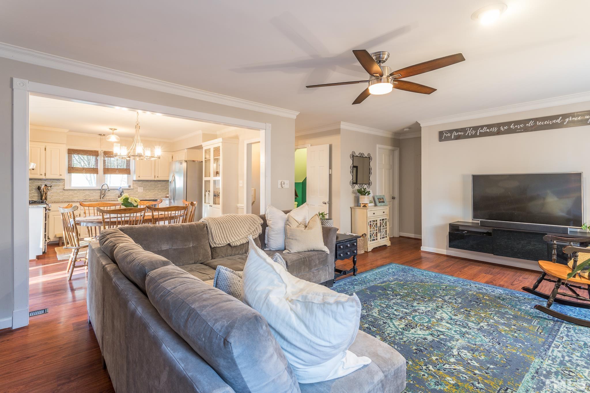 6924 Glendower Road Raleigh, NC 27613 - Photo 9 of 27 a living room with furniture and a flat screen tv