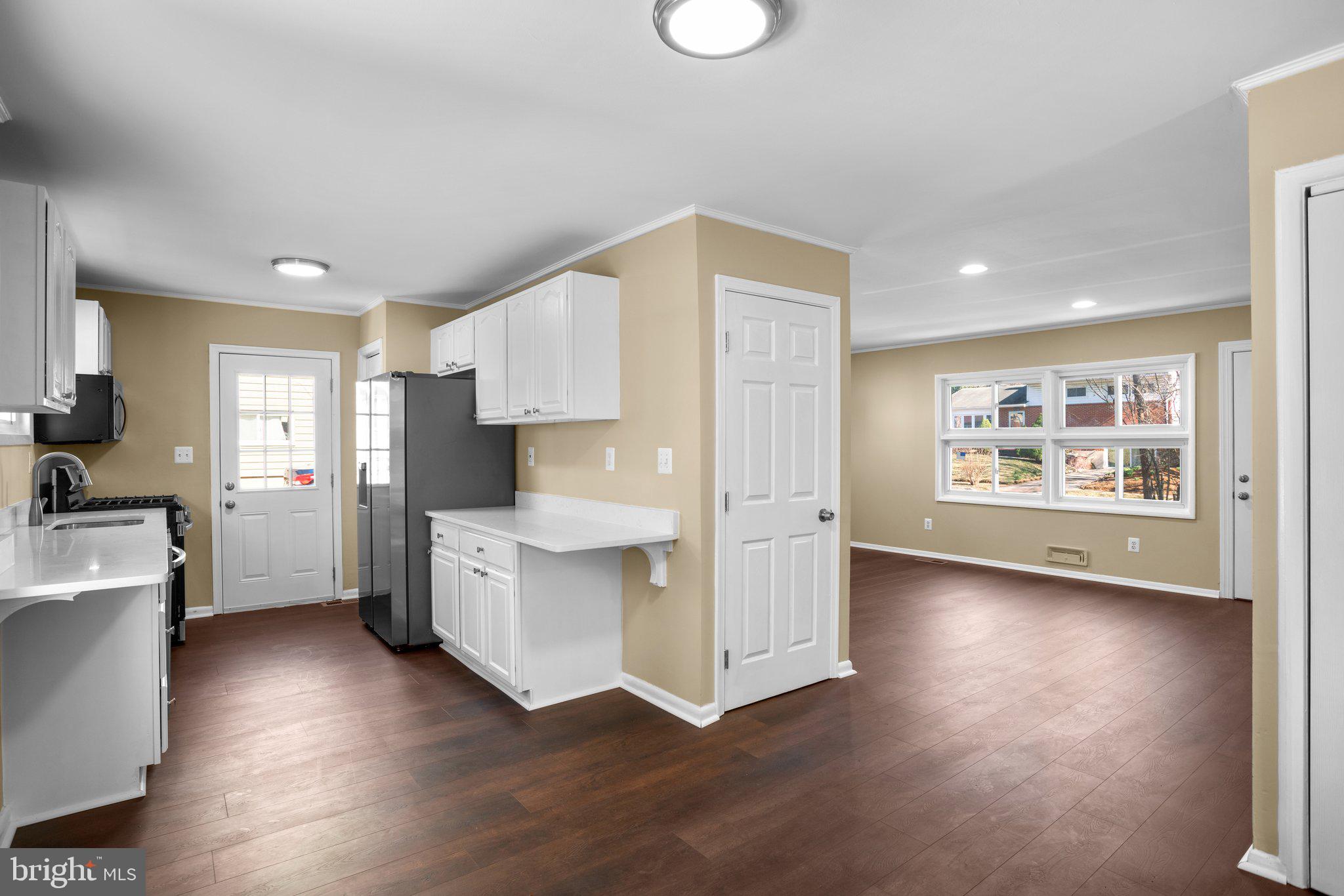 1030 Collwood Road Catonsville, MD 21228 - Photo 11 of 48 a kitchen with cabinets and wooden floors