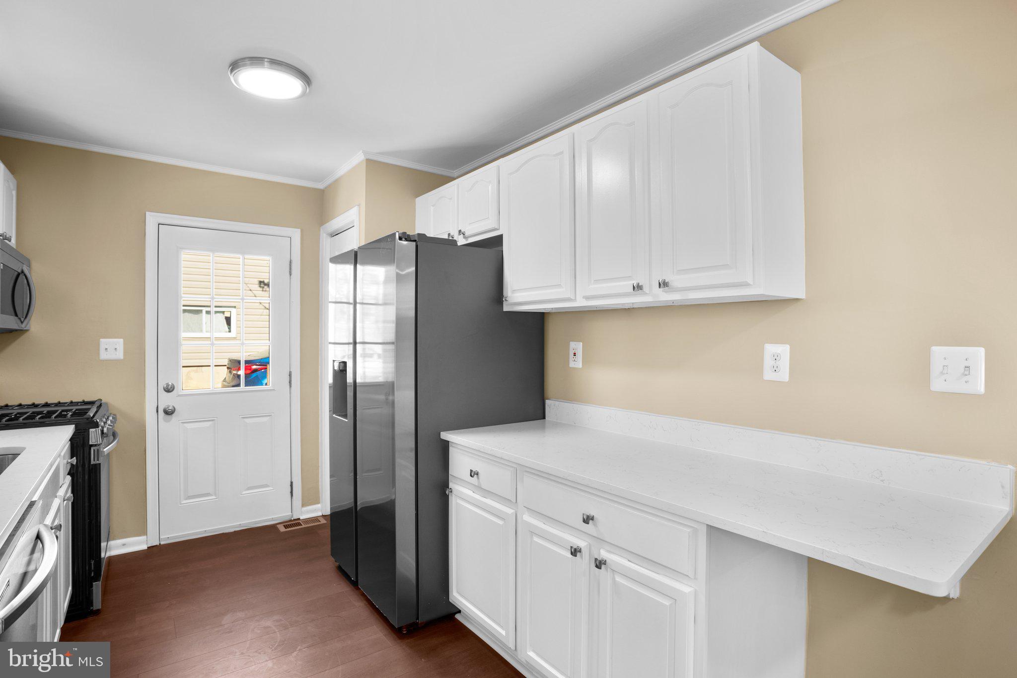 1030 Collwood Road Catonsville, MD 21228 - Photo 14 of 48 a kitchen with a refrigerator and a stove