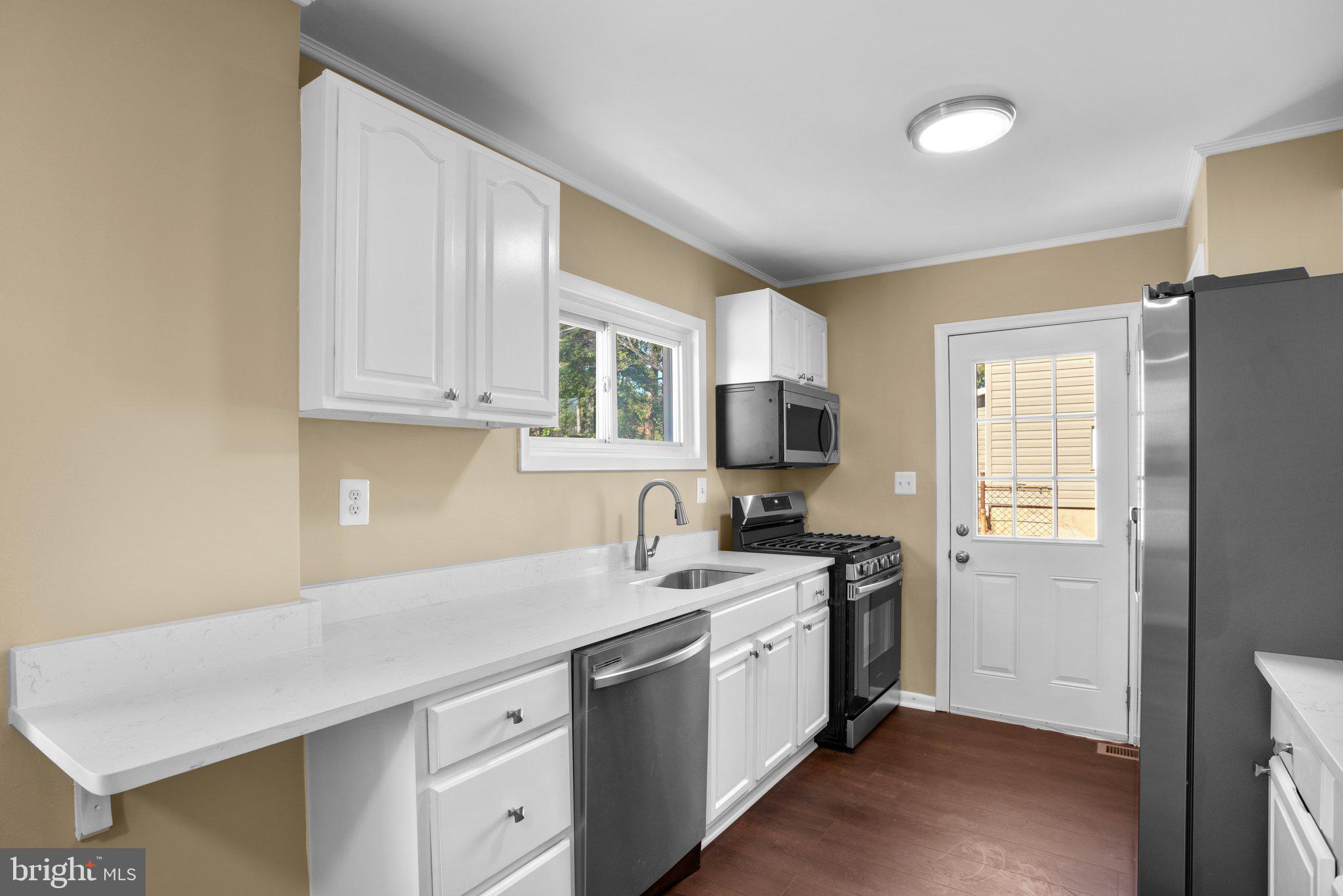 1030 Collwood Road Catonsville, MD 21228 - Photo 15 of 48 a kitchen with stainless steel appliances granite countertop a sink stove and refrigerator