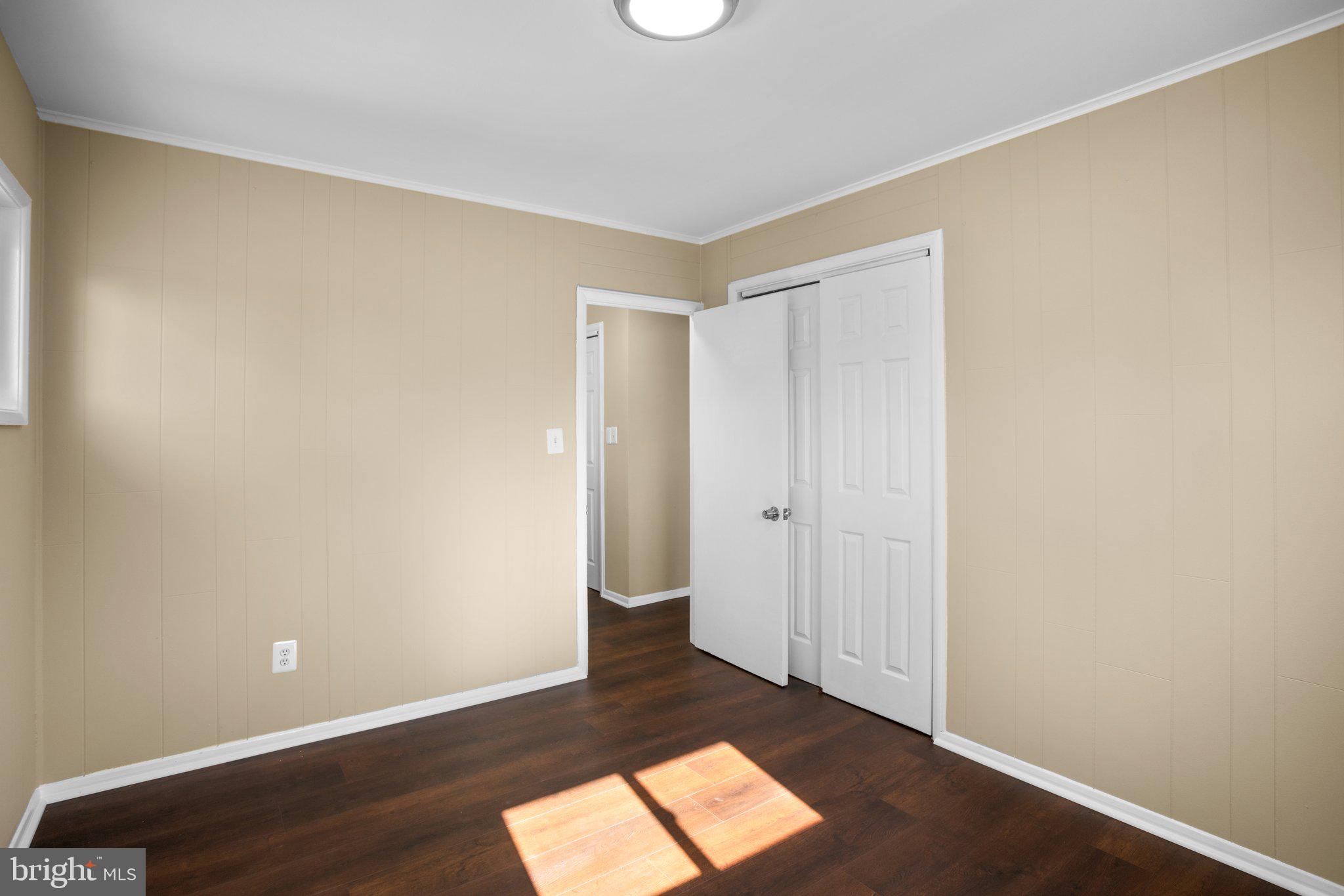 1030 Collwood Road Catonsville, MD 21228 - Photo 20 of 48 an empty room with wooden floor and windows
