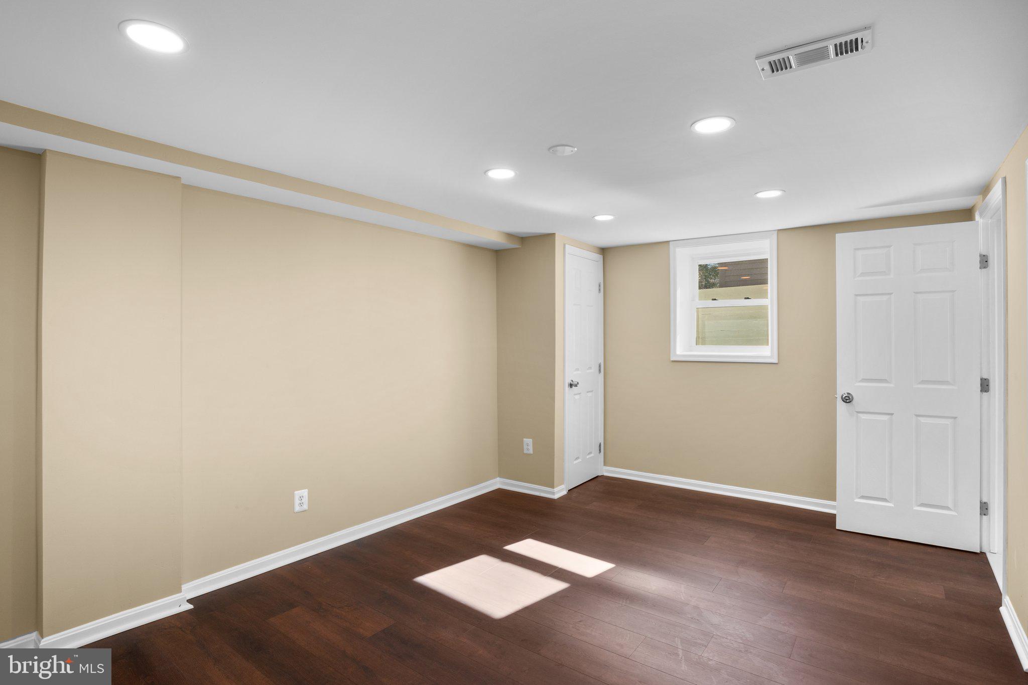 1030 Collwood Road Catonsville, MD 21228 - Photo 40 of 48 an empty room with wooden floor and windows