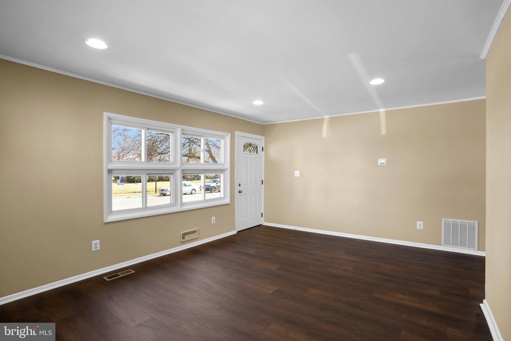 1030 Collwood Road Catonsville, MD 21228 - Photo 7 of 48 an empty room with wooden floor and windows
