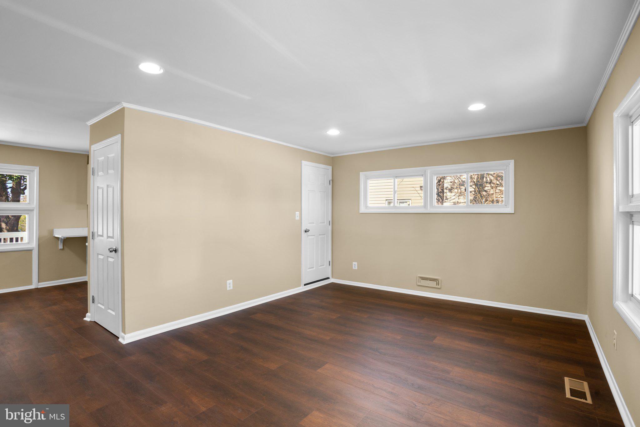 1030 Collwood Road Catonsville, MD 21228 - Photo 9 of 48 a view of an empty room with wooden floor and a window
