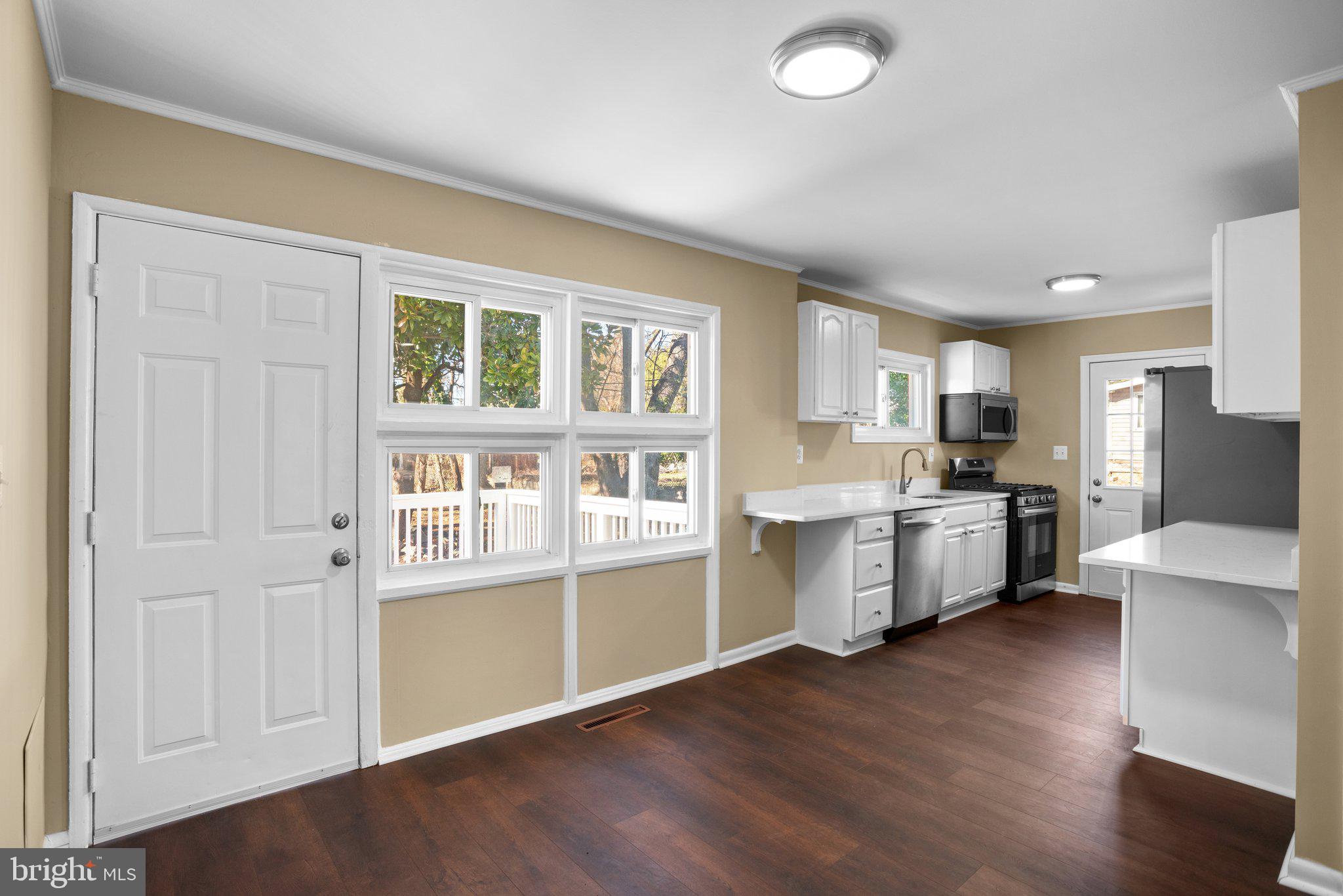 1030 Collwood Road Catonsville, MD 21228 - Photo 10 of 48 a kitchen with cabinets and wooden floor
