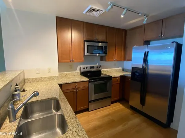 a kitchen with a sink stove and refrigerator