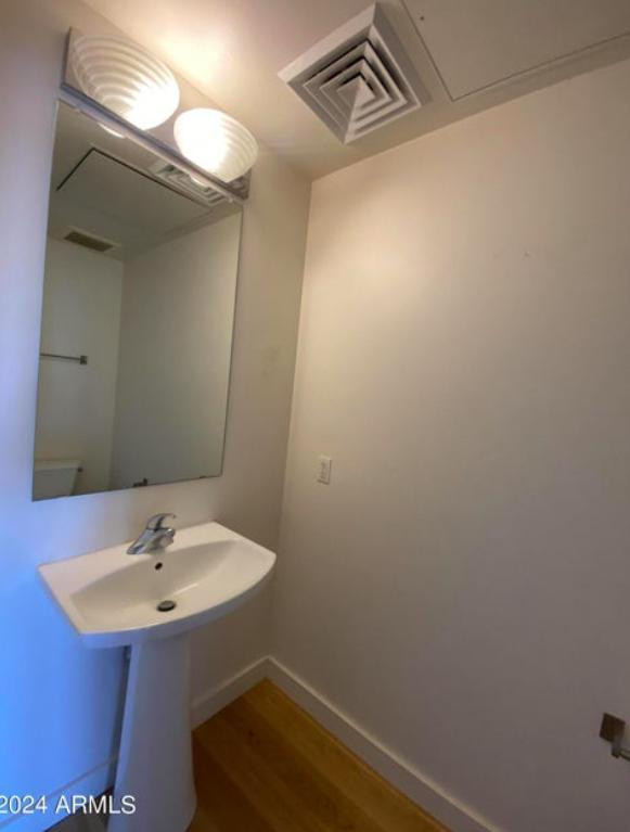 310 South 4th Street, Unit 1602 Phoenix, AZ 85004 - Photo 5 of 20 a bathroom with a sink and a mirror