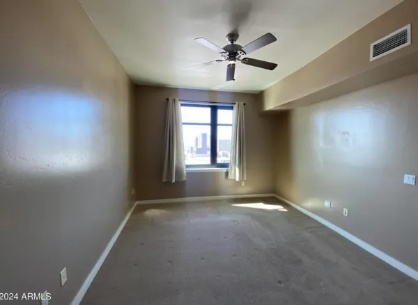 a view of a livingroom with a ceiling fan and window