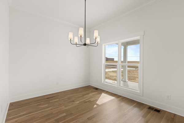 5558 Borthick Road Springfield, TN 37172 - Photo 12 of 43 a view of empty room with wooden floor and window