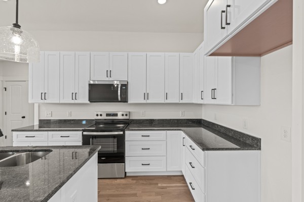 5558 Borthick Road Springfield, TN 37172 - Photo 17 of 43 a kitchen with granite countertop white cabinets and stainless steel appliances
