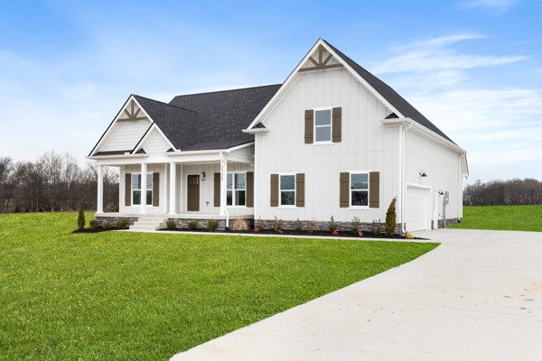 5558 Borthick Road Springfield, TN 37172 - Photo 4 of 43 a front view of a house with a garden and yard