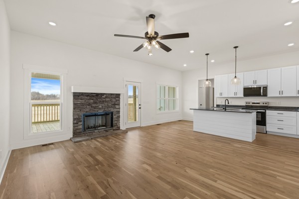 5558 Borthick Road Springfield, TN 37172 - Photo 8 of 43 a view of an empty room and kitchen with wooden floor