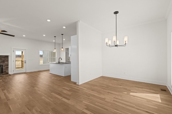 5558 Borthick Road Springfield, TN 37172 - Photo 10 of 43 a view of empty room with wooden floor and kitchen view