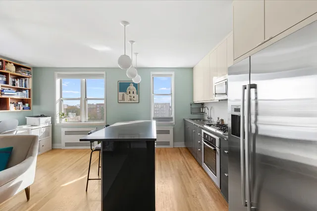 a living room with furniture and a book shelf