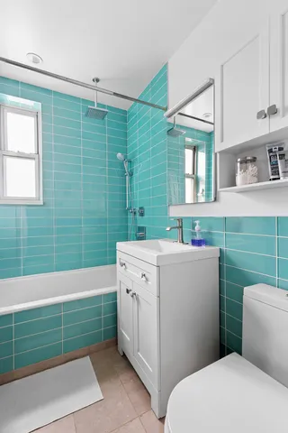 a kitchen with stainless steel appliances kitchen island granite countertop a refrigerator a sink dishwasher a stove and white countertops with wooden floor