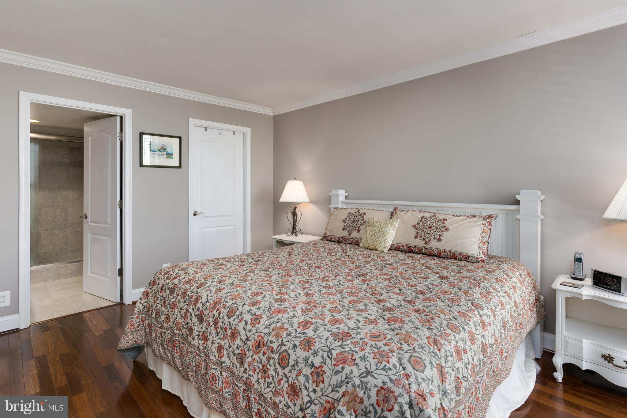 6800 Fleetwood Road, Unit 1017 McLean, VA 22101 - Photo 14 of 24 a bedroom with a bed and wooden floor