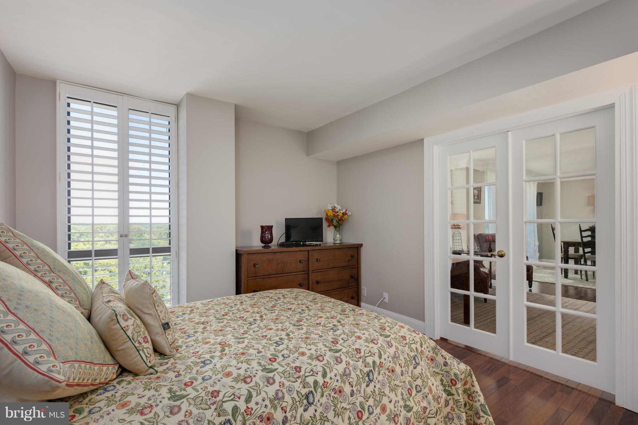 6800 Fleetwood Road, Unit 1017 McLean, VA 22101 - Photo 17 of 24 a bedroom with a bed and wooden floor