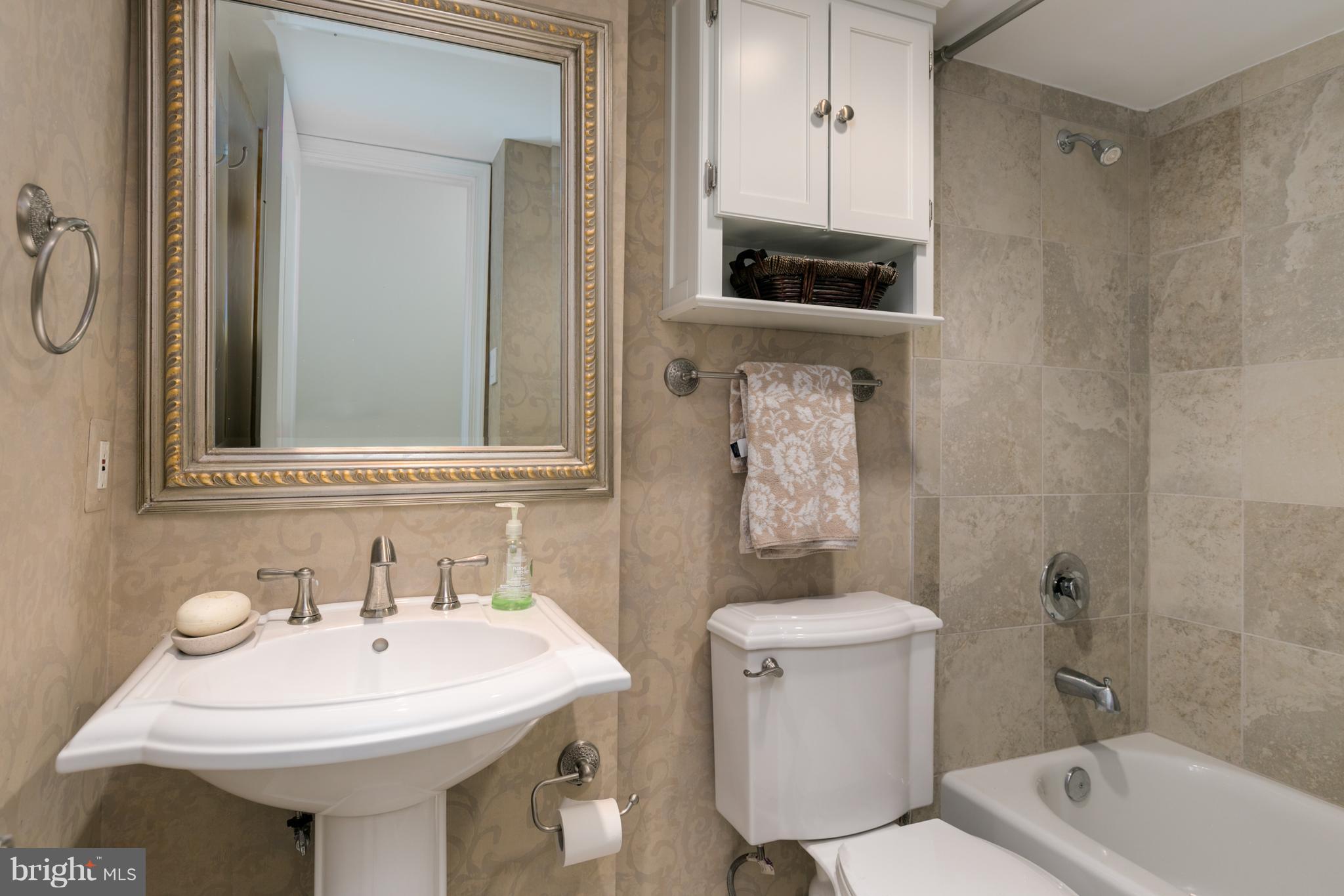 6800 Fleetwood Road, Unit 1017 McLean, VA 22101 - Photo 18 of 24 a bathroom with a sink a toilet and shower