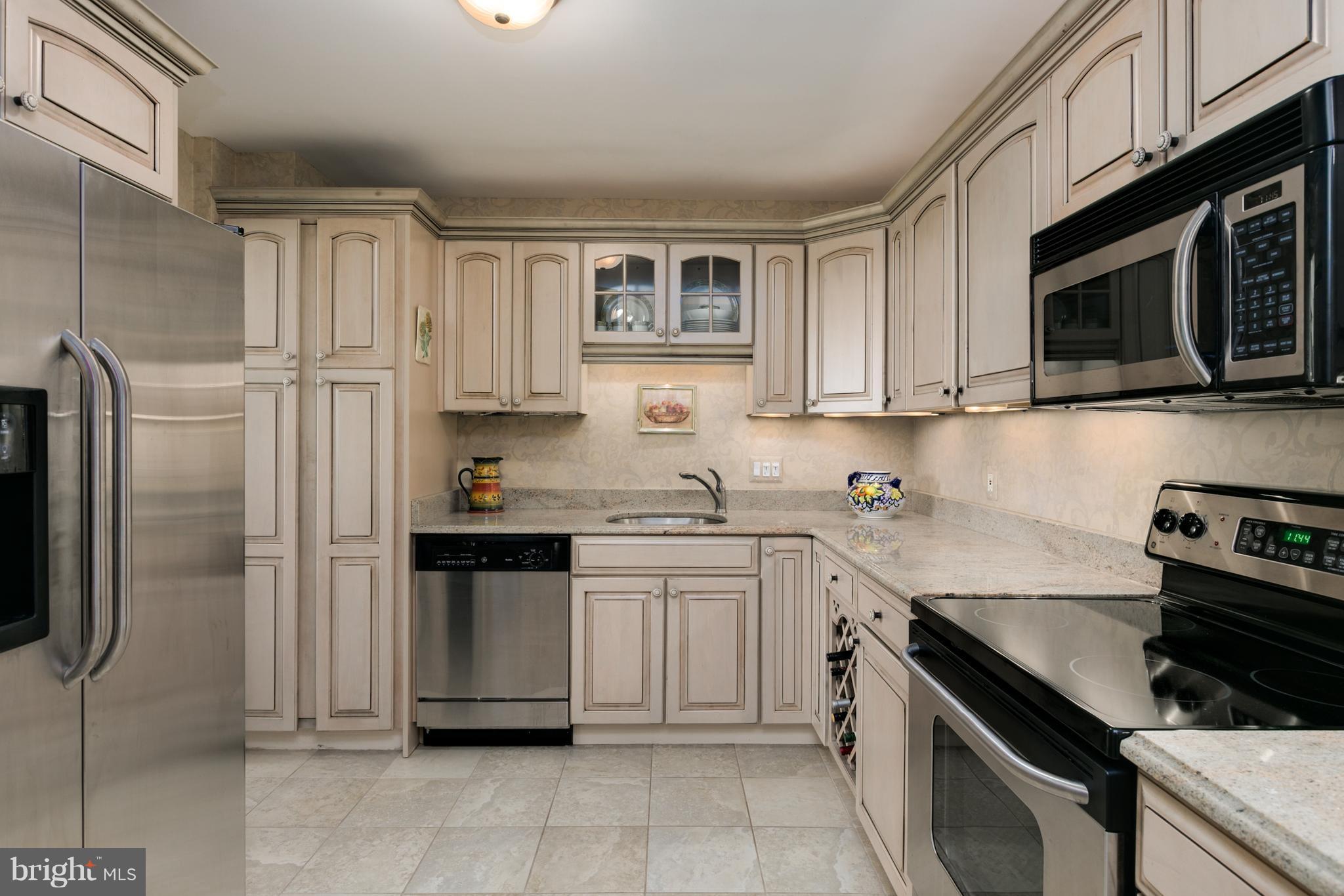 6800 Fleetwood Road, Unit 1017 McLean, VA 22101 - Photo 3 of 24 a kitchen with stainless steel appliances granite countertop a refrigerator stove and sink