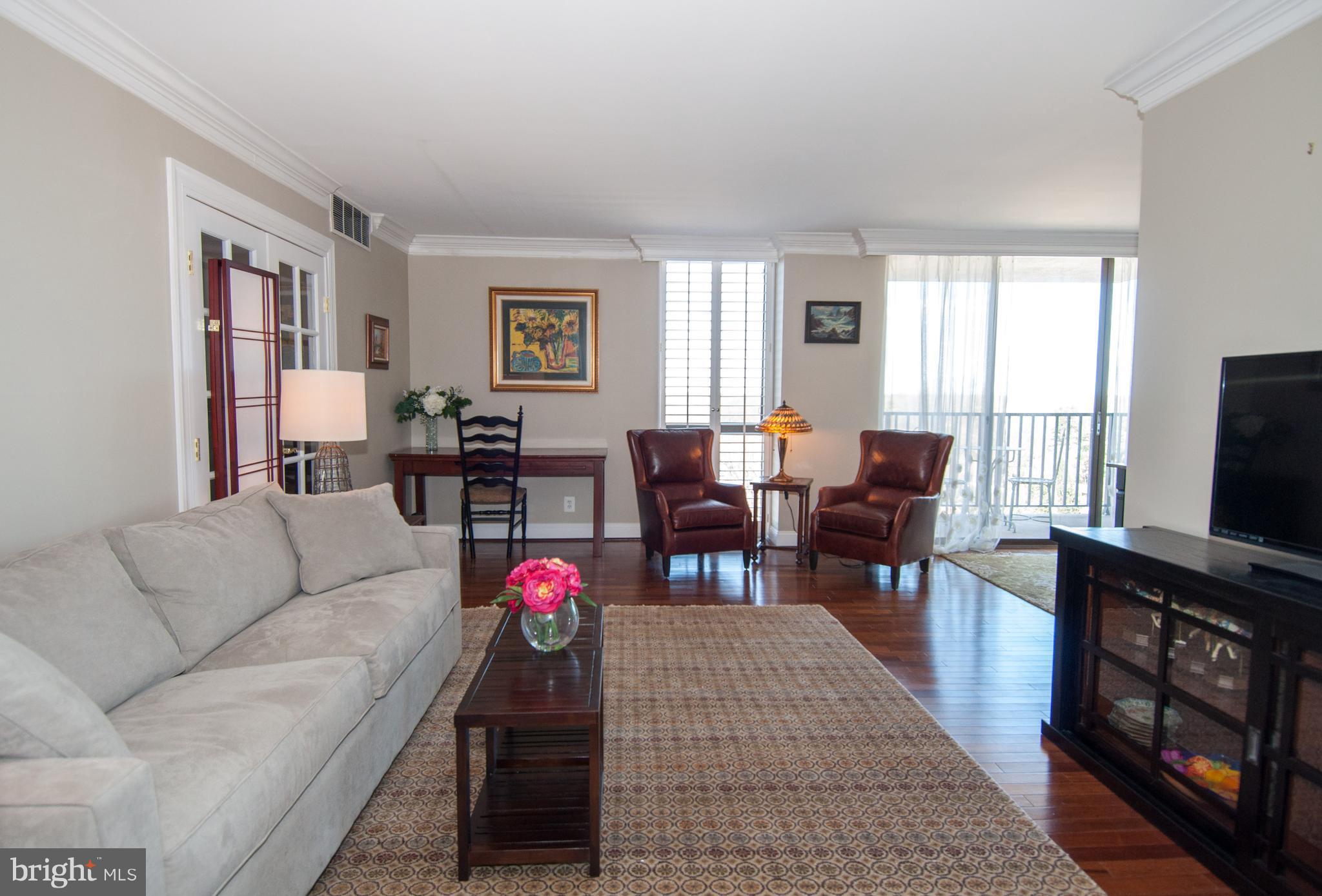 6800 Fleetwood Road, Unit 1017 McLean, VA 22101 - Photo 4 of 24 a living room with furniture flat screen tv and a window