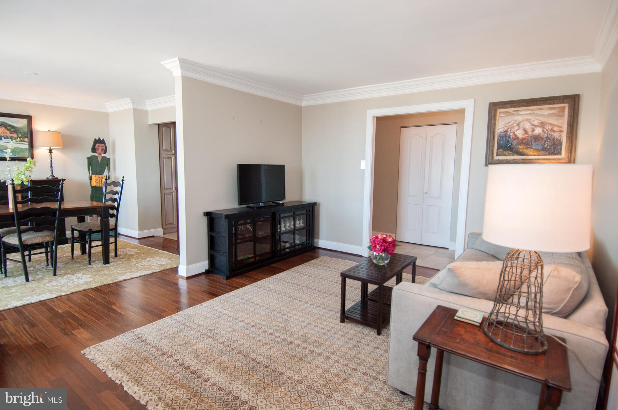 6800 Fleetwood Road, Unit 1017 McLean, VA 22101 - Photo 5 of 24 a living room with furniture and a flat screen tv with wooden floor