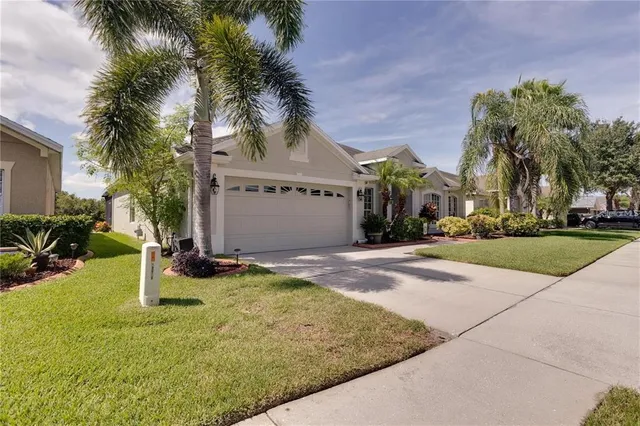 a view of a house with palm trees