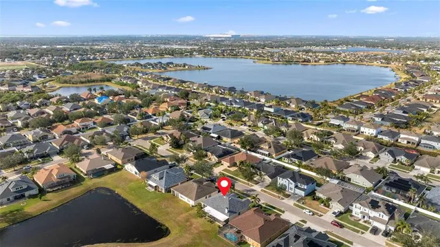 an aerial view of residential houses with outdoor space and ocean view
