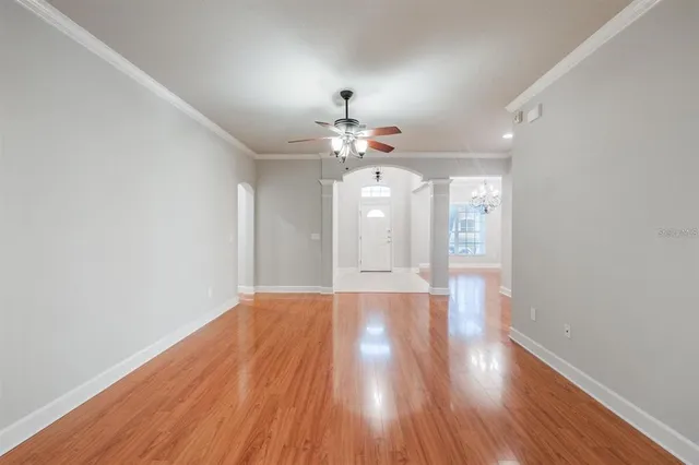 a view of an empty room with wooden floor