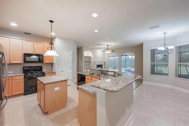 a kitchen with stainless steel appliances granite countertop stove top oven and refrigerator