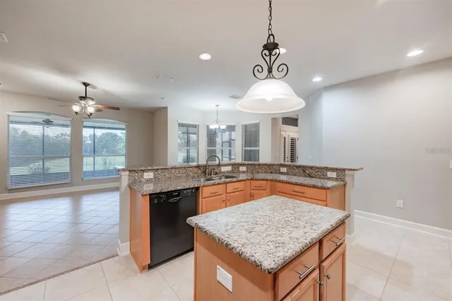a view of a kitchen with refrigerator and a sink