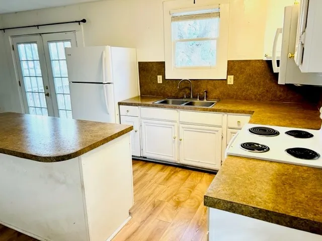 a kitchen with a sink a stove and refrigerator