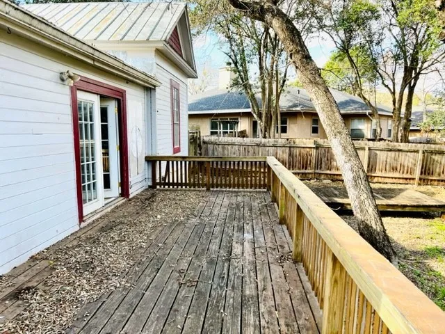 a view of a house with wooden deck