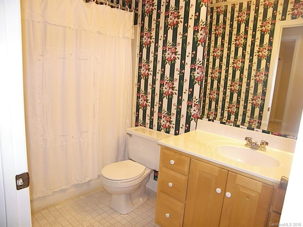 9913 Fairway Ridge Road Charlotte, NC 28277 - Photo 14 of 18 a bathroom with a sink a toilet and shower curtain