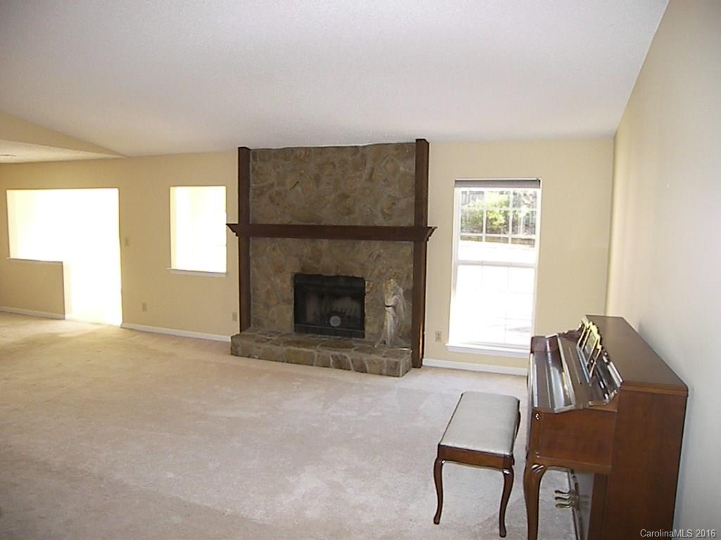 9913 Fairway Ridge Road Charlotte, NC 28277 - Photo 3 of 18 a living room with furniture and a fireplace