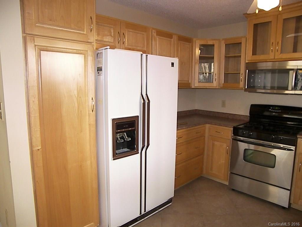 9913 Fairway Ridge Road Charlotte, NC 28277 - Photo 8 of 18 a kitchen with stainless steel appliances granite countertop a refrigerator and a stove