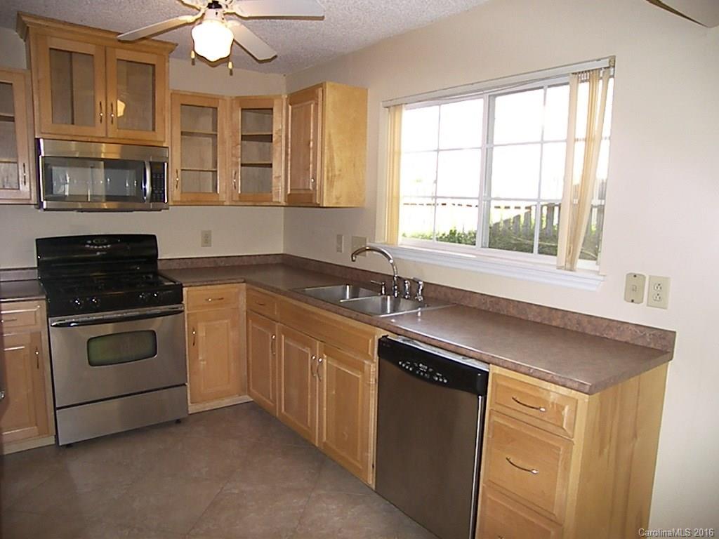 9913 Fairway Ridge Road Charlotte, NC 28277 - Photo 9 of 18 a kitchen with granite countertop a stove sink and microwave